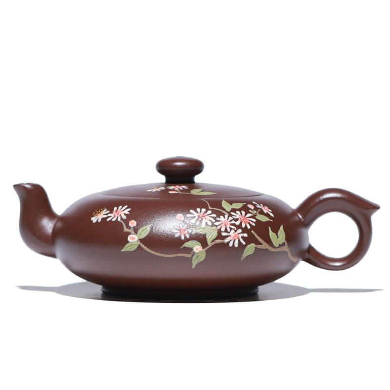 Handmade Yixing purple sand teapot with floral design, showcasing traditional craftsmanship and artistry.