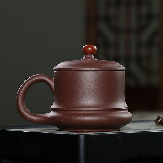 Handmade Yixing purple sand cup with a smooth finish, elegant design, perfect for tea lovers.