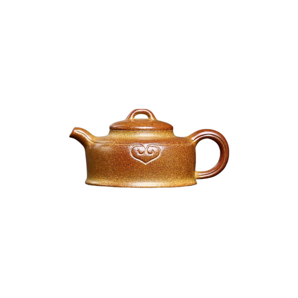 Handmade Yixing purple sand teapot with unique heart design, crafted using ancient methods for a classic tea experience.