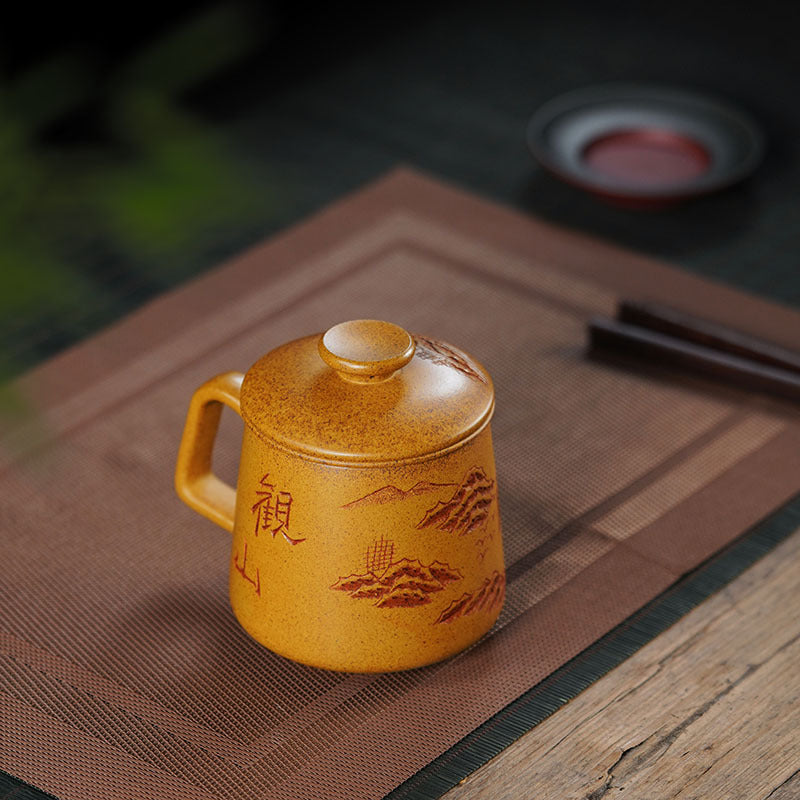 Handmade Yixing purple sand cup with lid, featuring mountain view design, perfect for high-end tea experiences.