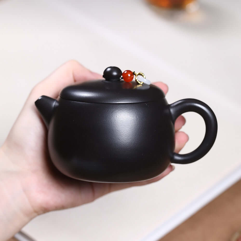 Handmade Yixing purple sand teapot with round jade drop, ideal for kung fu tea set, showcasing original craftsmanship.