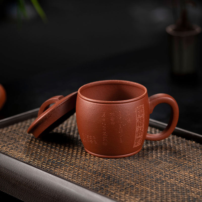 Handmade Yixing purple sand cup with lid on tray, showcasing authentic craftsmanship and elegant design for tea lovers.