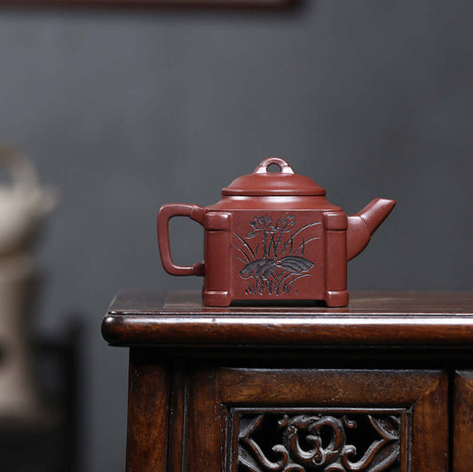 Handmade Yixing purple sand teapot featuring intricate floral design, perfect for Kung Fu tea ceremonies.