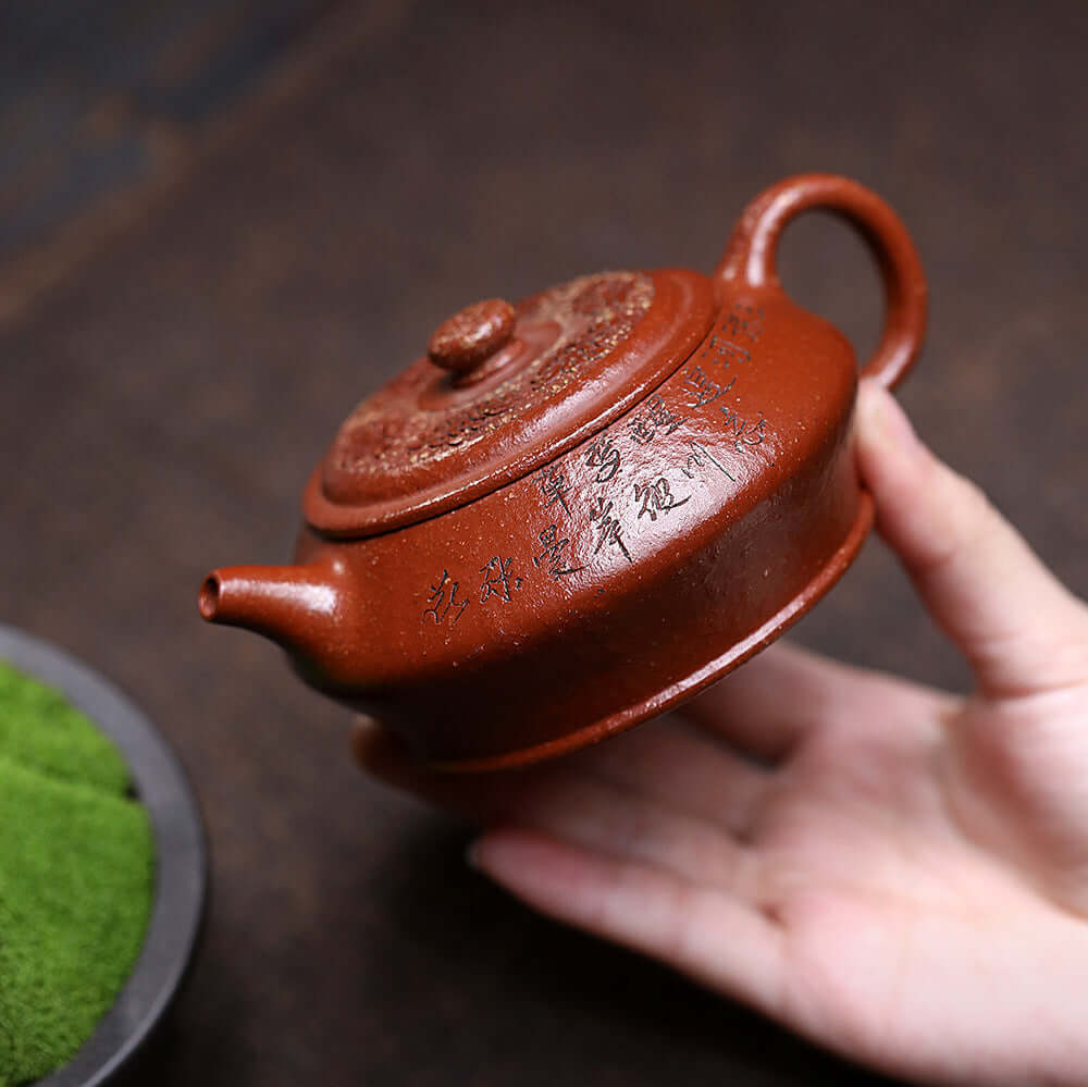 Handmade Yixing purple sand teapot with engraved design, perfect for kung fu tea set, showcasing original craftsmanship.
