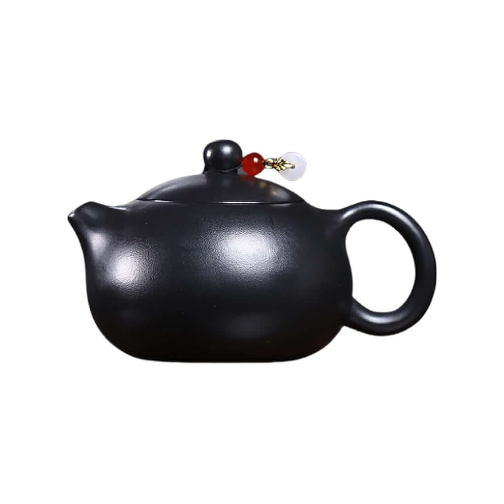 Handmade Yixing purple sand teapot with black iron stone and inverted handle, perfect for Kung Fu tea set.