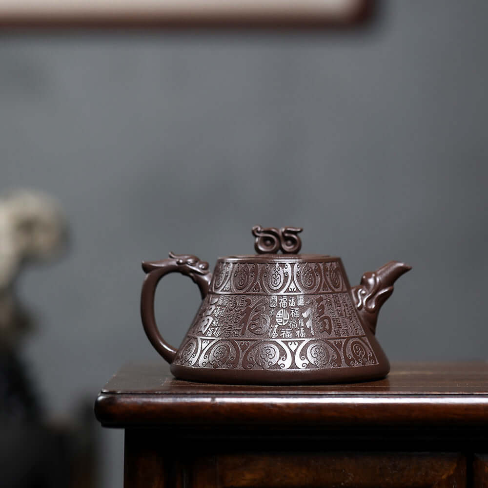 Handmade Yixing purple sand teapot with intricate designs, perfect for authentic Kung Fu tea ceremonies.