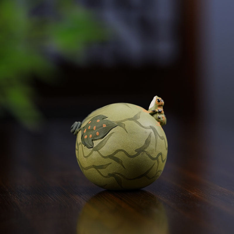 Handmade Yixing purple sand tea pet ornament featuring a playful frog design for tea enthusiasts.