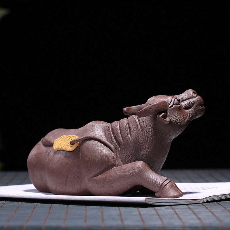 Handmade Yixing purple sand tea pet cow sculpture for tea ceremony decoration, symbolizing wealth and blessings.