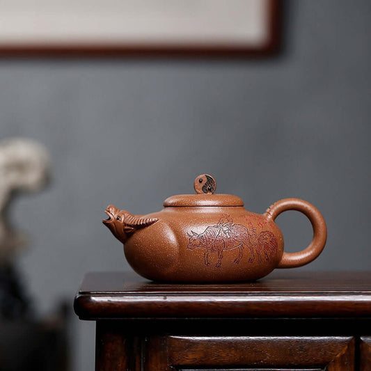 Handmade Yixing purple sand teapot with cattle design, perfect for kung fu tea sets and tea enthusiasts.