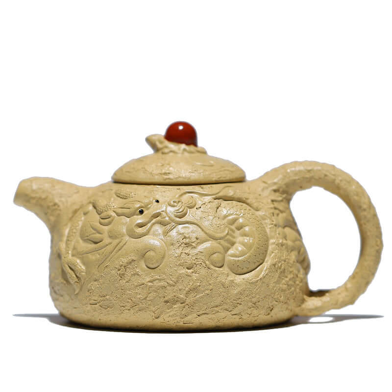 Handmade Yixing purple sand teapot with dragon design and red bead, showcasing traditional craftsmanship and unique texture.