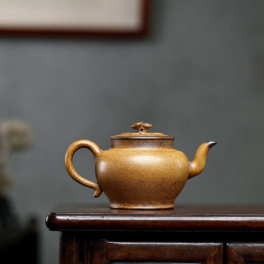 Handmade Yixing purple sand teapot crafted from high-temperature mud, featuring traditional engraving and unique design.