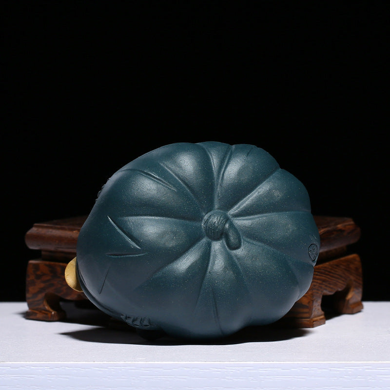 Handmade Yixing purple sand teapot shaped like a lotus leaf, perfect for tea ceremonies and decoration.