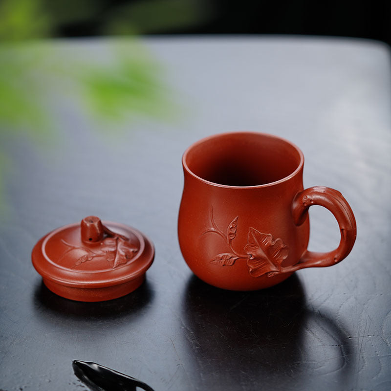 Handmade Yixing purple sand tea cup with lid, showcasing exquisite craftsmanship and natural clay texture.
