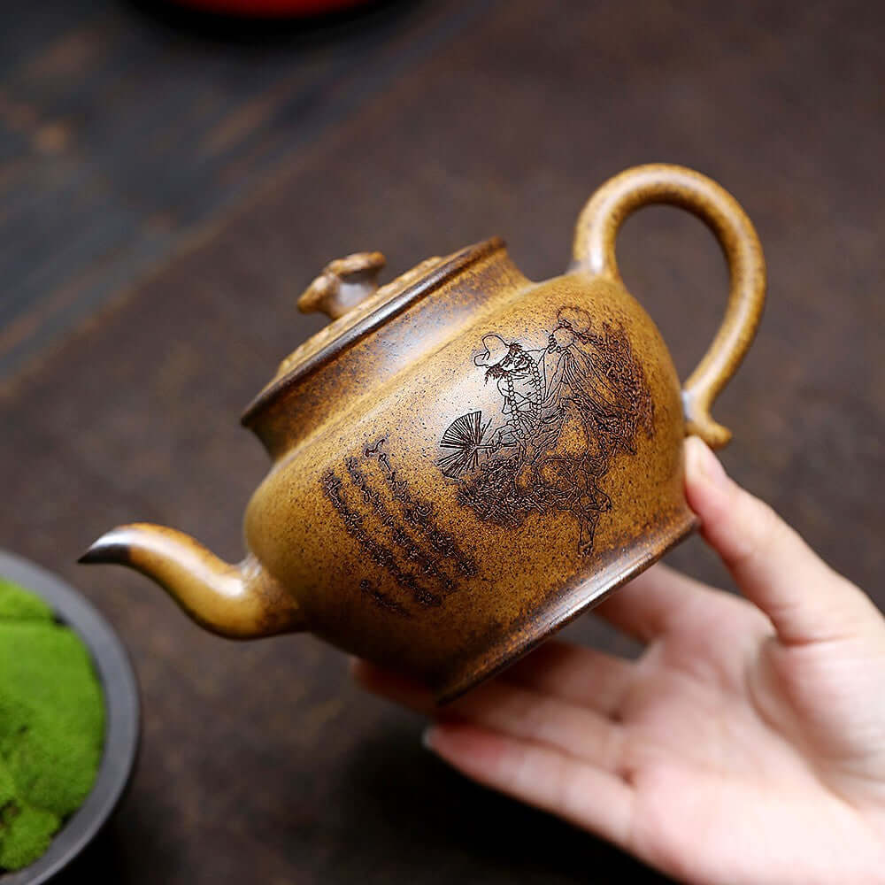 Handmade Yixing purple sand teapot with engraved design, ideal for kung fu tea ceremonies.