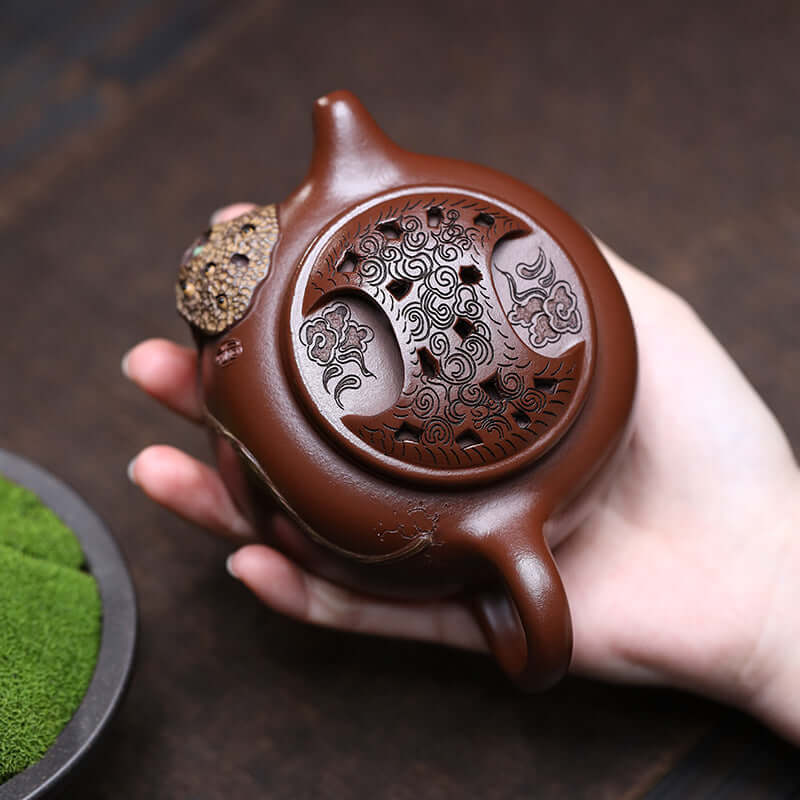 Handmade Yixing purple sand teapot featuring intricate design, ideal for home kung fu tea sets.