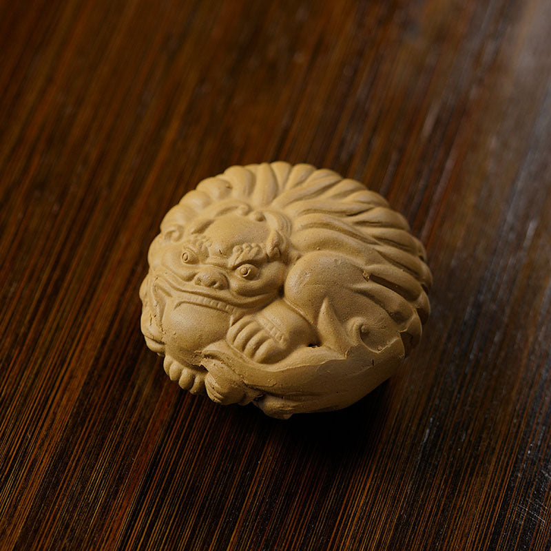 Handmade Yixing purple sand clay sculpture of a protective lion ornament for tea tables.
