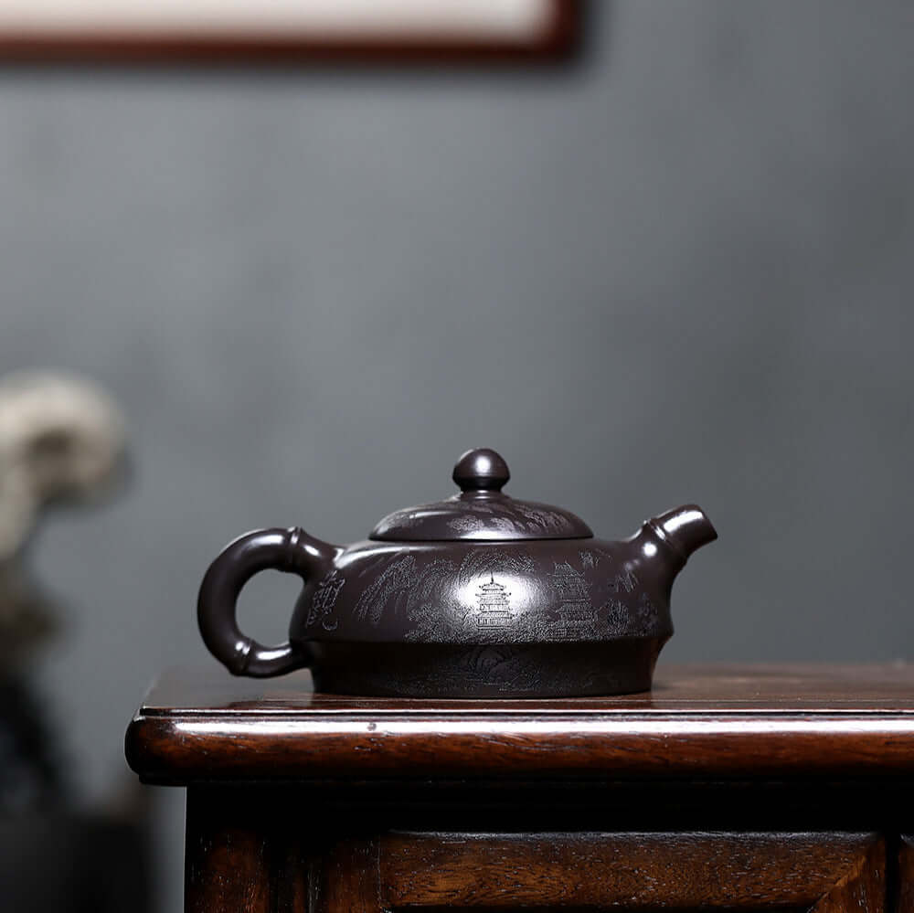 Handmade Yixing purple sand teapot with intricate designs, perfect for a kung fu tea set.