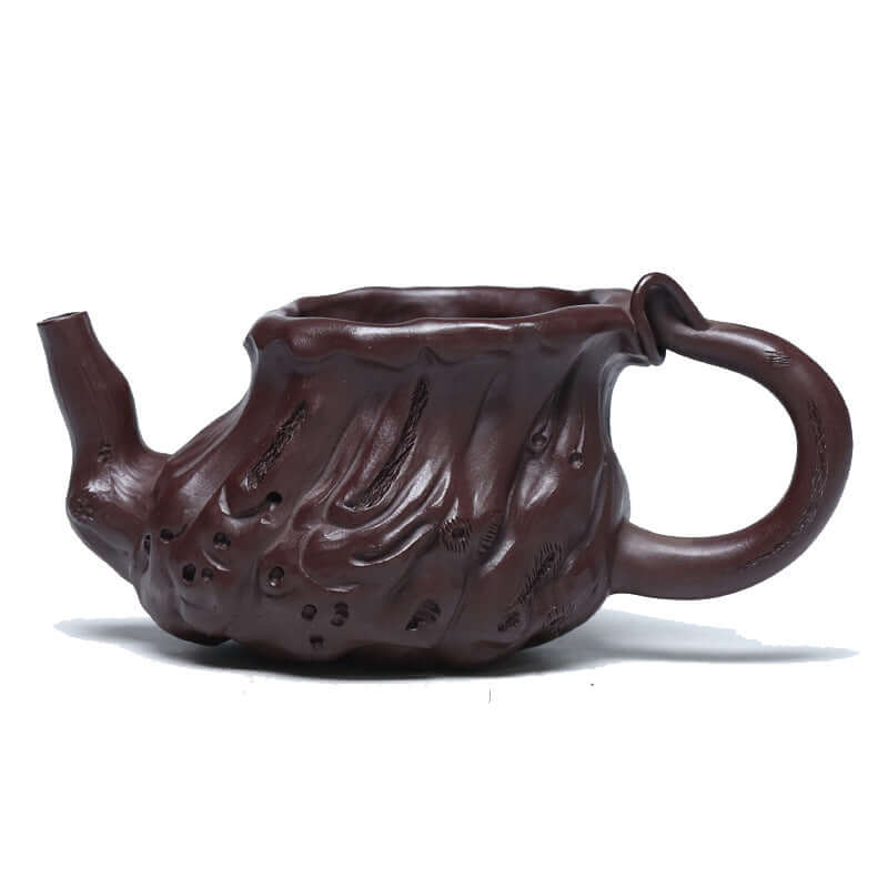 Handmade Yixing purple sand teapot with intricate design, showcasing traditional craftsmanship and natural elegance.