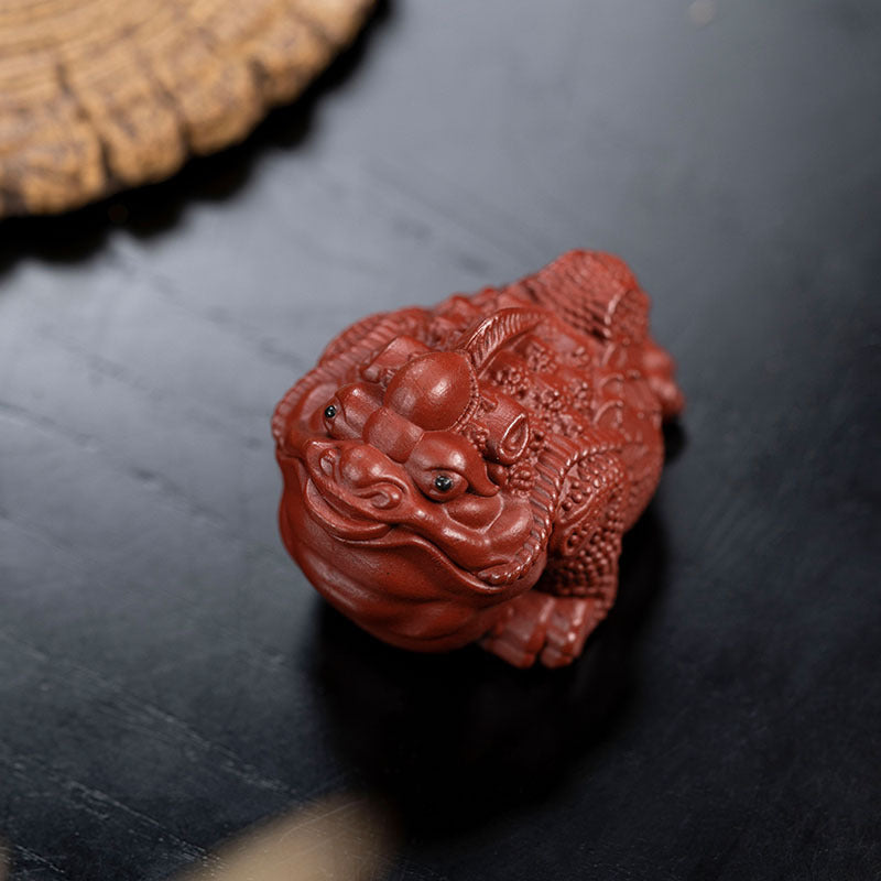 Handmade Yixing purple sand tea pet ornament, a unique craft ideal for tea lovers and collectors.