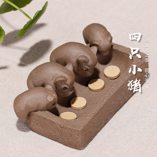 Handmade purple sand piglet tea pet ornament with coins for tea ceremonies, showcasing unique Yixing craftsmanship.