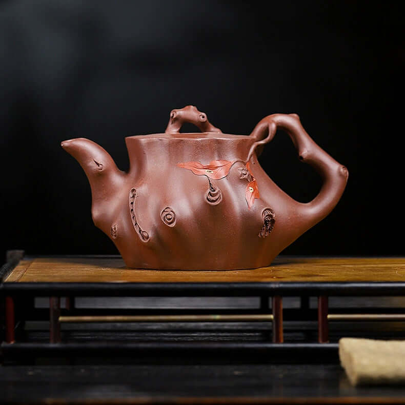 Handmade Yixing purple sand teapot with unique bionic design, crafted from original purple sand for tea brewing.