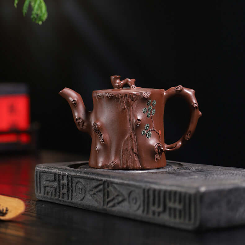 Handmade Yixing purple sand teapot, crafted by Yixing artisans, featuring a unique tree stump design, ideal for tea ceremonies.