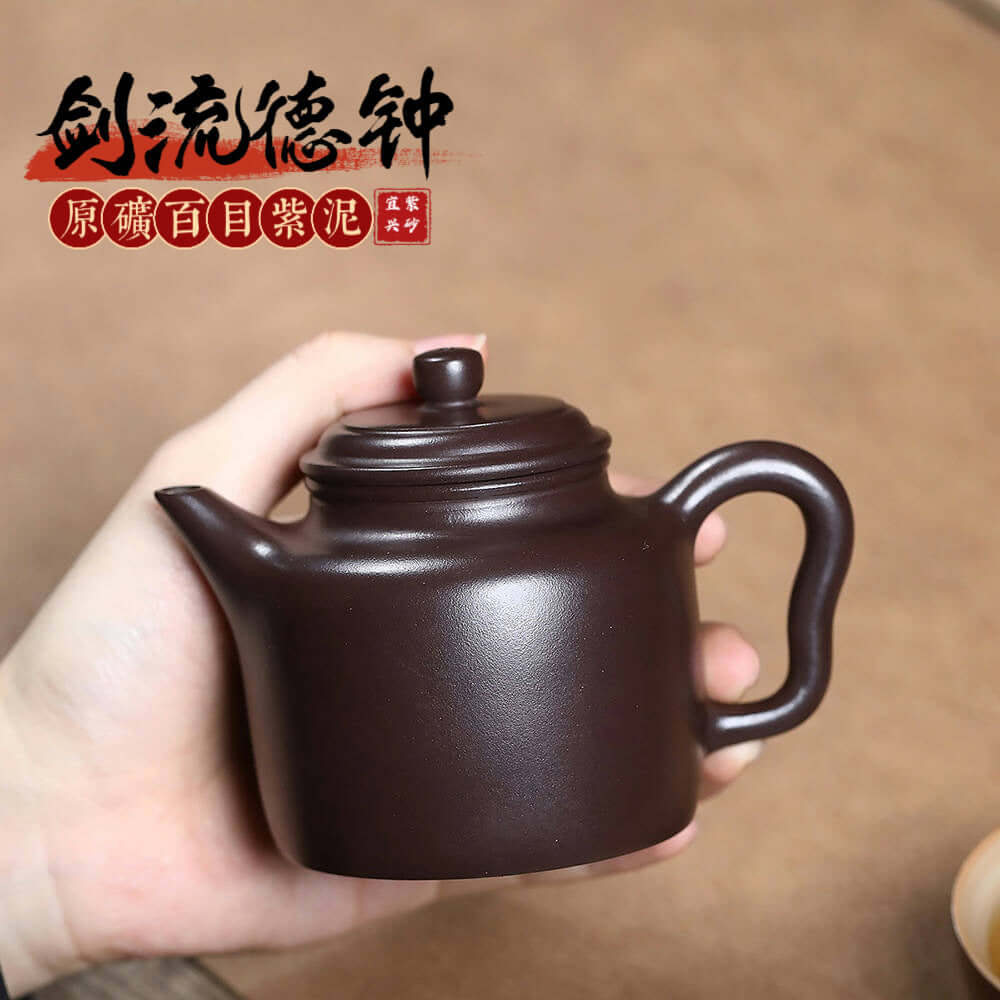 Handmade Yixing purple sand teapot, crafted by skilled artisans, perfect for Kung Fu tea sets and tea enthusiasts.