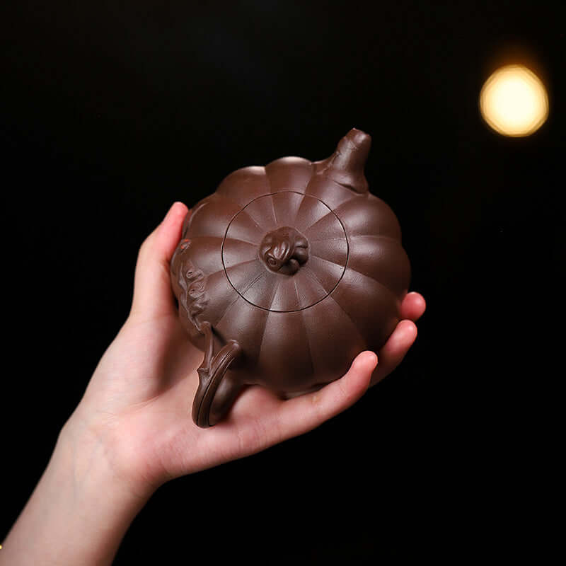 Handmade Yixing purple sand teapot, shaped like a pumpkin, showcasing original craftsmanship and design.
