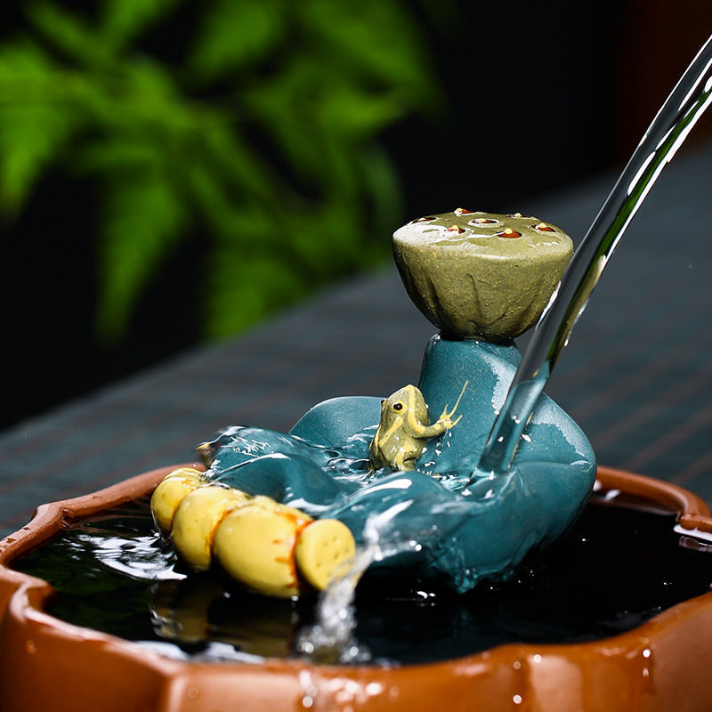 Handmade Yixing purple sand frog lotus leaf decoration with water feature in tea pot holder.