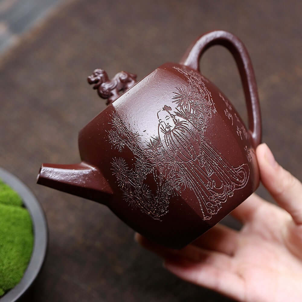 Handmade Yixing purple sand teapot featuring intricate carving of a figure and lion, perfect for kung fu tea sets.