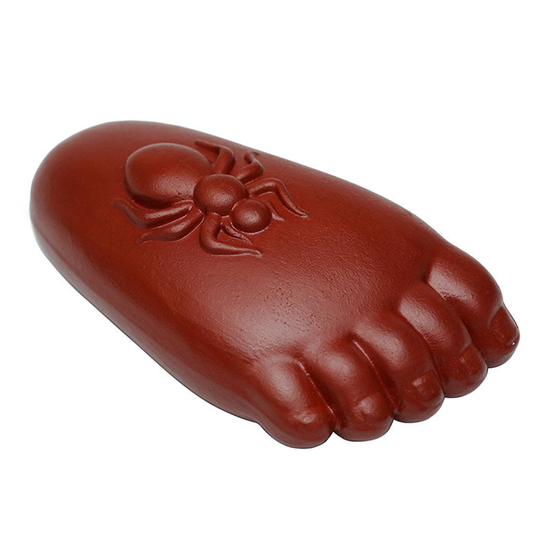 Handmade Yixing purple sand tea pet ornament in the shape of a foot with a spider design, perfect for tea lovers.