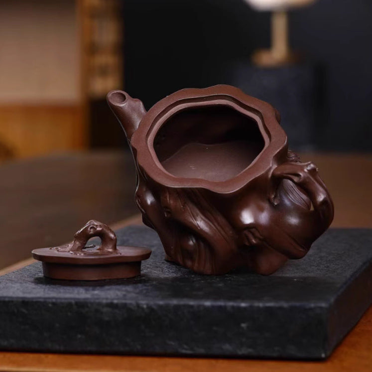 Handmade Yixing purple sand teapot with unique design, showcasing craftsmanship and original purple sand material.
