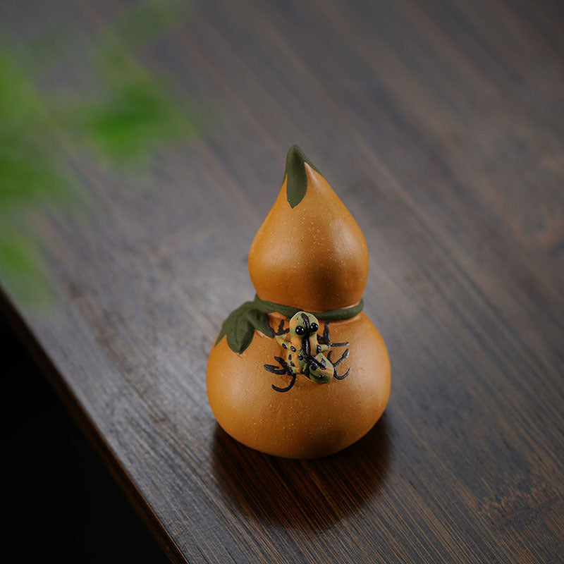 Handmade Yixing purple sand tea pet sculpture, gourd design with intricate detailing, perfect for tea lovers and collectors.