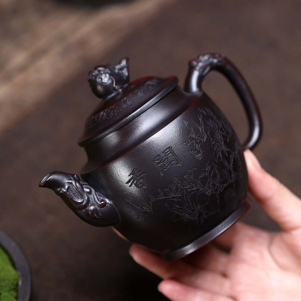 Handmade Yixing purple sand teapot crafted from ancient red mud, featuring intricate designs and perfect for kung fu tea sets.