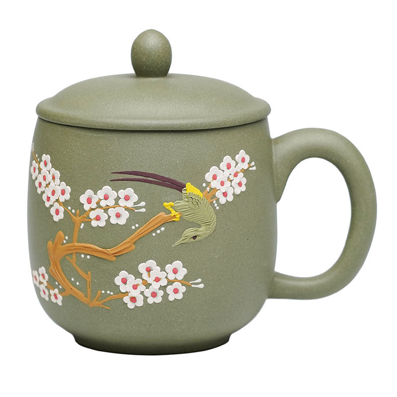 Handmade Yixing purple sand tea cup with floral design and lid, perfect for tea connoisseurs.