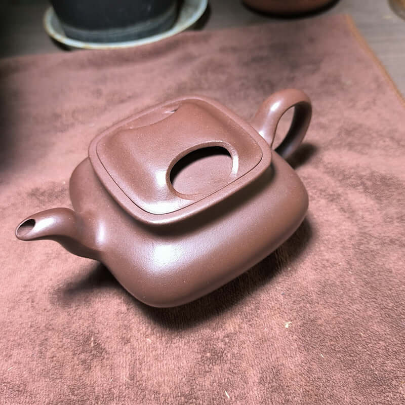 Handmade Yixing purple sand teapot with cow cover, showcasing original mineral purple clay craftsmanship.