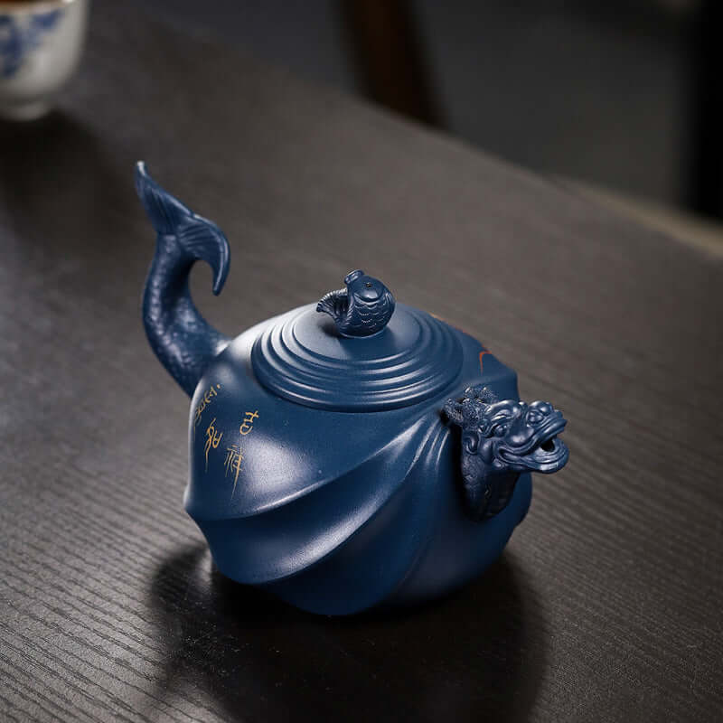 Handmade Yixing purple sand teapot with fish dragon design, featuring intricate details and classic craftsmanship.