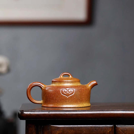 Handmade Yixing purple sand teapot crafted from raw ore, showcasing ancient techniques with a heart design.