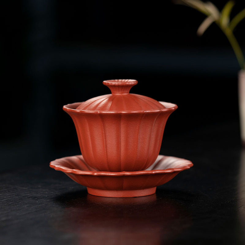 Handmade Yixing purple sand chrysanthemum tea cup and saucer, crafted from original raw ore for an elegant tea experience.