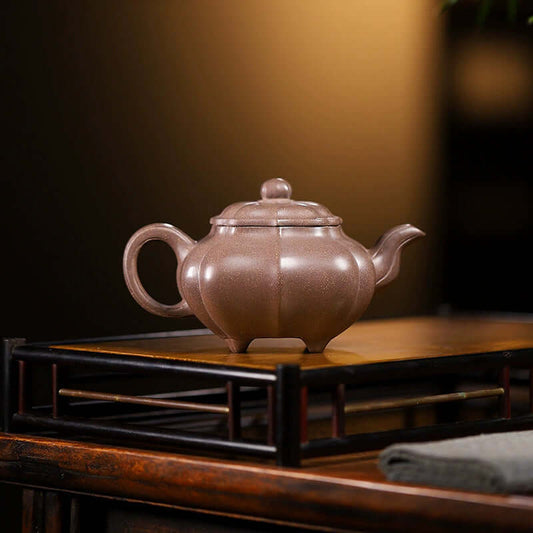 Handmade Yixing purple sand teapot, crafted by skilled artisans, featuring a beautiful ribbed design.