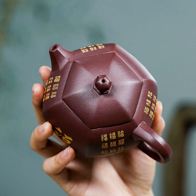 Handmade Yixing purple sand teapot, hexagonal design, featuring intricate carvings and original craftsmanship.