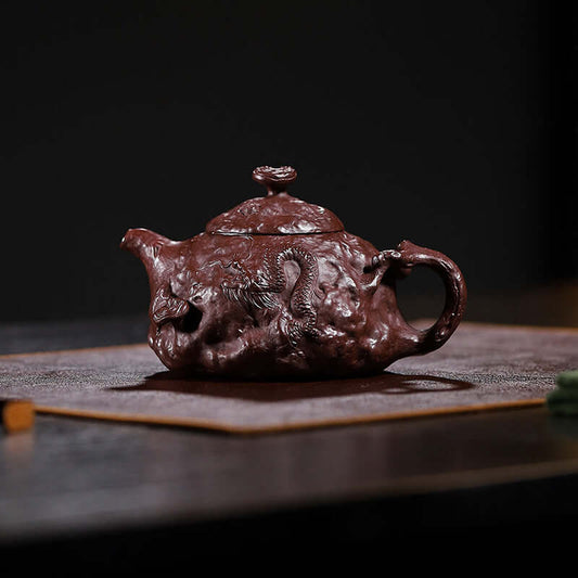 Handmade Yixing purple sand teapot with intricate design, crafted by skilled artisans for high-end tea experiences.