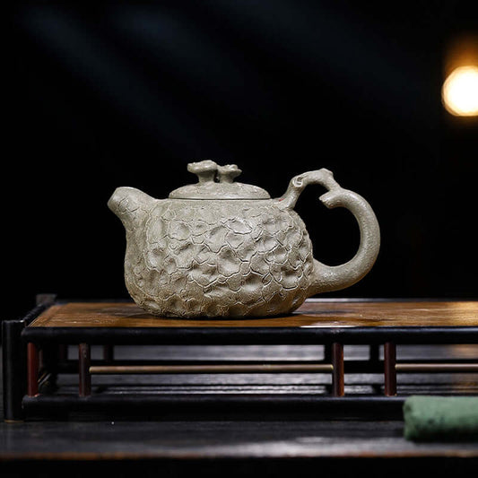 Handmade Yixing purple sand teapot with unique texture, perfect for tea brewing and elegant display.