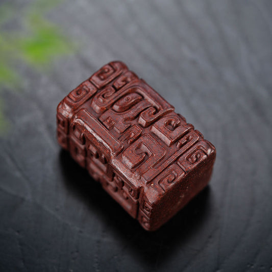 Handmade Yixing Zisha tea pet with embossed totem pattern, crafted from original purple sand, perfect for tea set accessories.