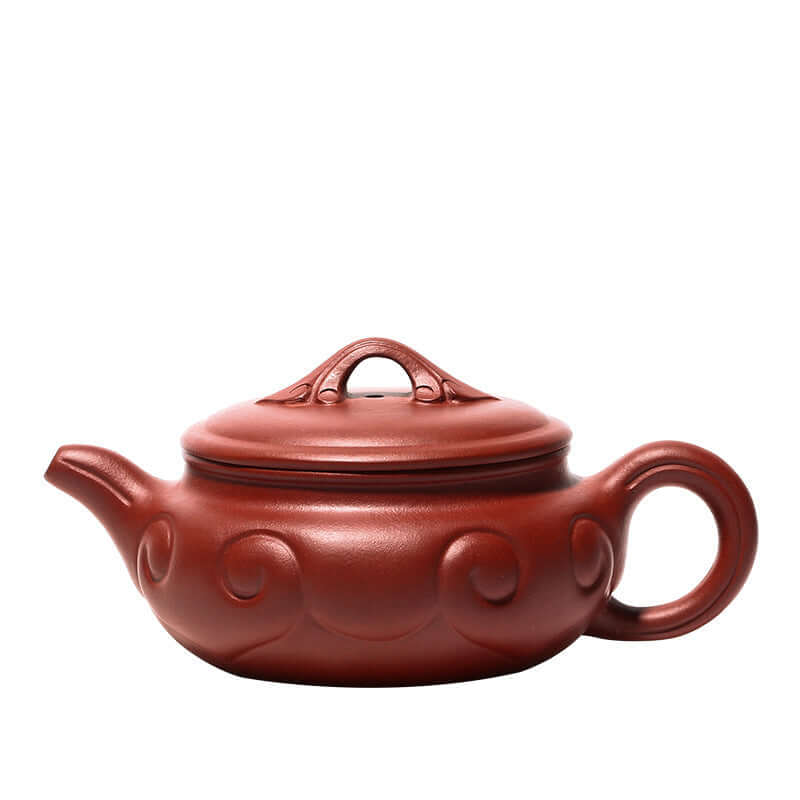 Handmade Yixing purple sand teapot featuring elegant curves and traditional design, perfect for tea enthusiasts.