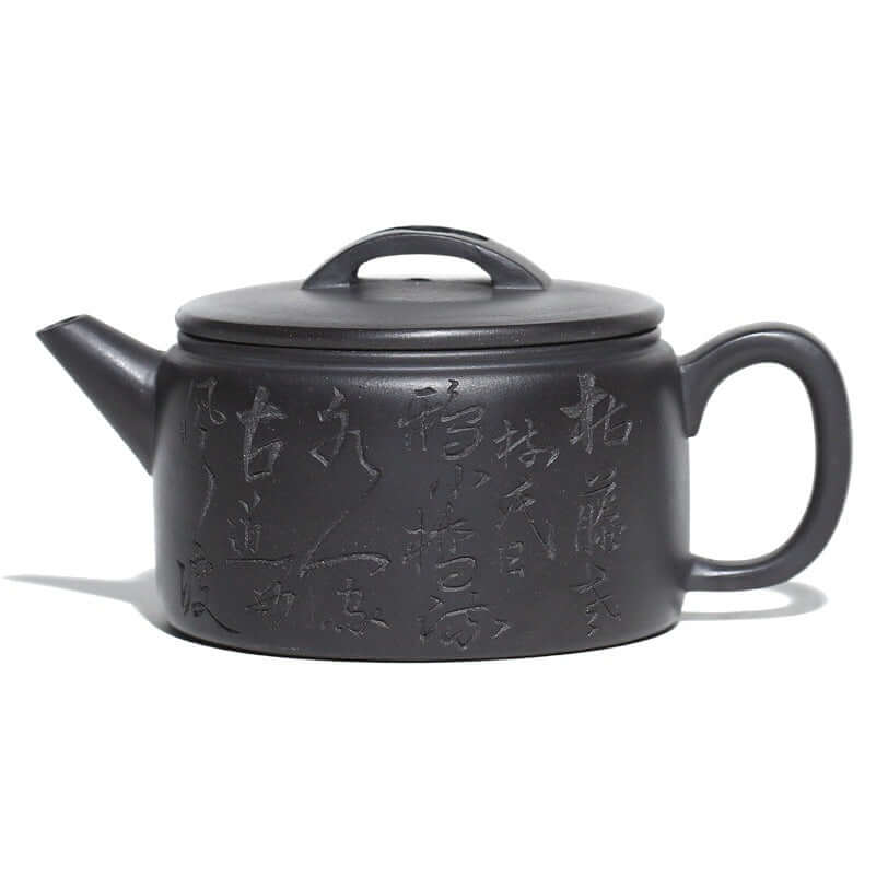 Handmade Yixing purple sand teapot with intricate carvings and a sturdy handle, showcasing traditional craftsmanship.