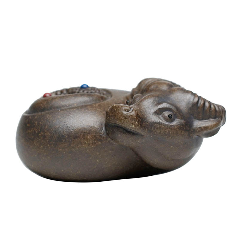 Handmade Yixing purple sand ox ornament, designed for tea play and decoration, showcasing unique craftsmanship.