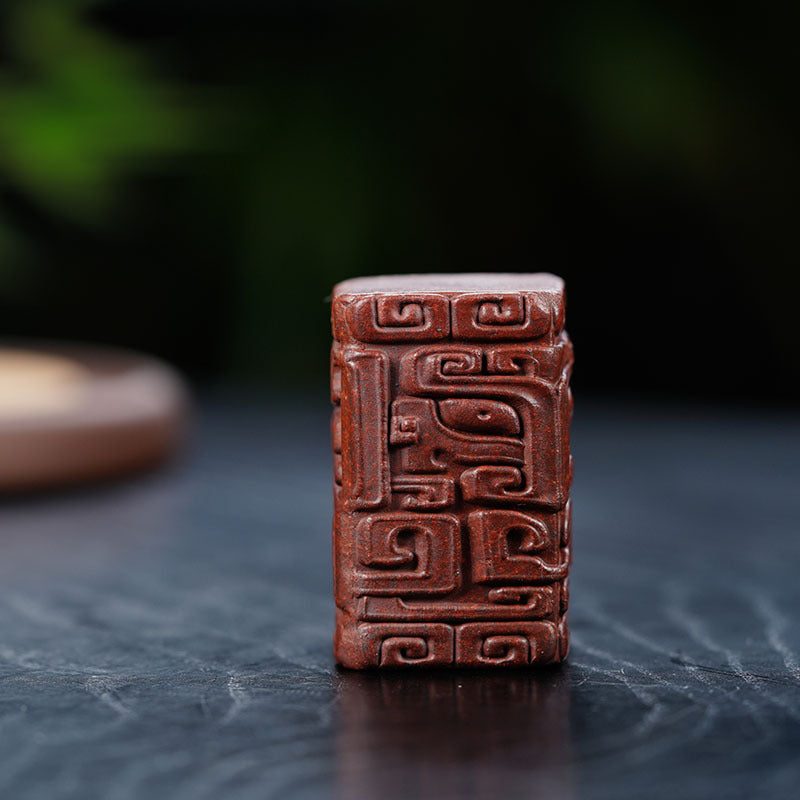 Handmade Yixing purple sand tea pet with embossed totem pattern, perfect for tea ceremonies and household decor.