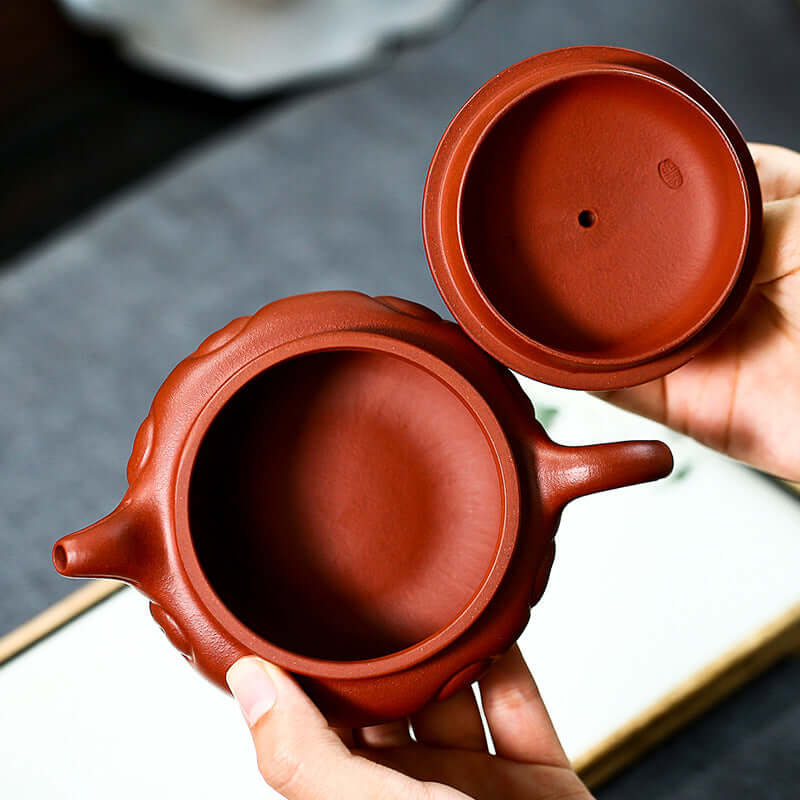Handcrafted Yixing purple sand teapot showcasing the interior design, highlighting its smooth texture and craftsmanship.