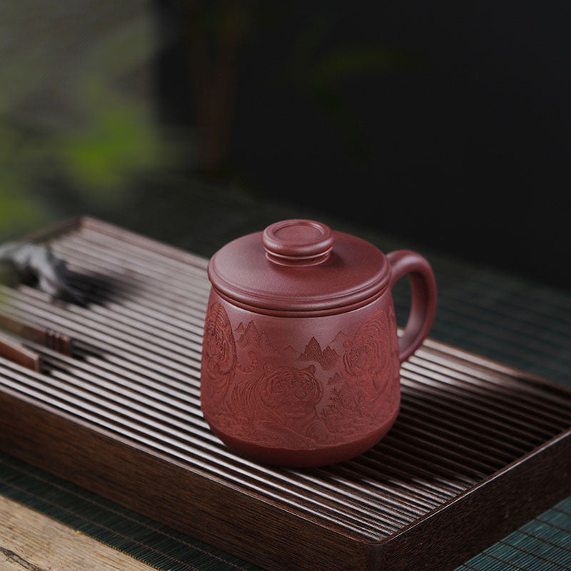 Handmade Yixing purple sand tea cup with engraved design, perfect for enjoying tea at the office or as a gift.